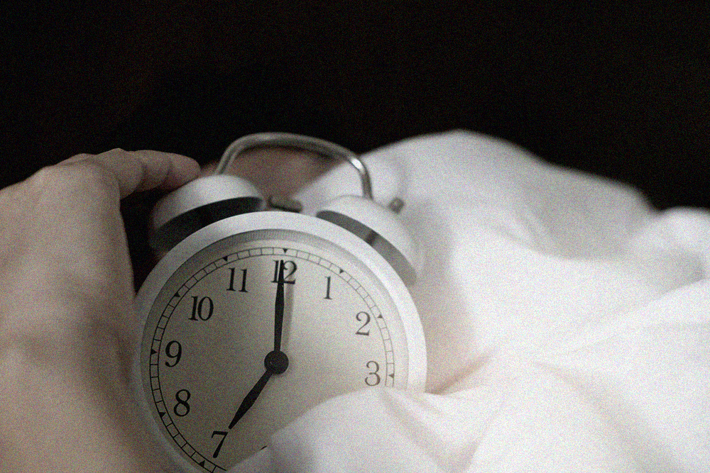 Classic alarm clock in a bed